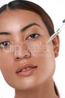 Ive tried many others but this one is the best. a beautiful young woman posing with a serum dropper against her face.