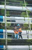 There are many facets to the construction sector. a young man and woman using a digital tablet while working at a construction site.