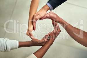 Group of businesspeople hands making creative circle shape together in an office at work. Above diverse business professionals support, motivate and unity during a meeting in a corporate office