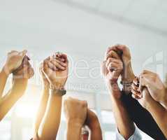 People raising their arms hands and holding each others hands to protest together gesture as a team and group in unity. Men and women showing teamwork, support and community close up with copy space
