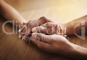 Holding hands in support and comfort, showing love, care and consoling a friend. Two people together in unity, solidarity and trust, showing kindness, hope and faith while helping and bonding closeup