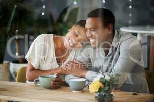 Love as warm as a fresh cuppa. a young couple spending time together at a cafe.