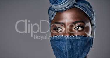 Covering your face doesnt have to mask your beauty. a beautiful young woman wearing a denim head wrap and mask.