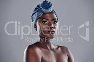 The world needs your magic. a beautiful young woman wearing a denim head wrap while posing against a grey background.