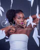 Your wings already exist - all you have to do is fly. Studio portrait of a beautiful young woman posing with paper birds against a black background.