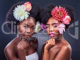 Theres nothing more beautiful than a woman who knows her worth. two beautiful women posing together with flowers in their hair.