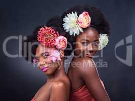Forget diamonds, wear flowers instead. two beautiful women posing together with flowers in their hair.
