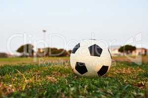 Ready for kickoff. Closeup shot of a soccer ball on an empty sports field.