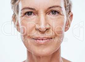 Our skin ages as we age. a beautiful mature woman posing against a white background.