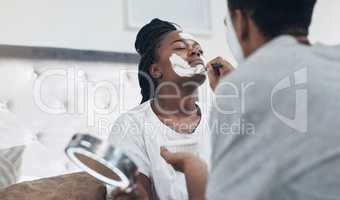 Its time to turn the meaning of masculinity around. a young couple getting homemade facials together at home.