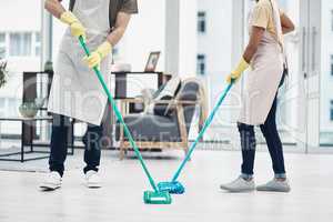 Double up on disinfectant power. an unrecognisable couple mopping the floor at home.