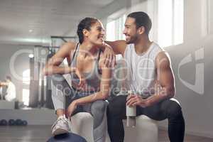 Our health is good and our relationship is even better. two young athletes sitting together at the gym.