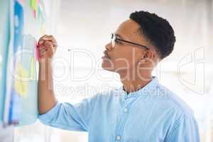 The tiniest detail can determine your direction. a young businessman having a brainstorming session in a modern office.