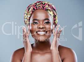 I choose to love myself. Studio portrait of a beautiful young woman applying face lotion against a grey background.