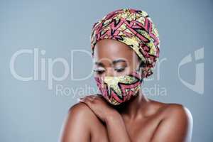 Even in lockdown, never neglect your skin. Studio shot of a beautiful young woman wearing a mask against a grey background.