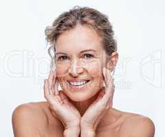 Were not going to look young forever but we can look good. a beautiful mature woman posing against a white background.