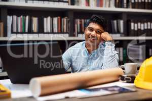 I give new meaning to the word homemaker. Portrait of a young architect working at his desk in a modern office.