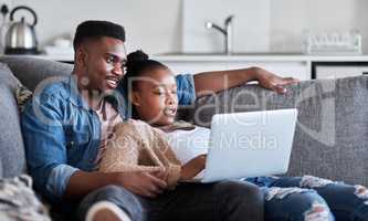 Uncapped wifi keeps the boredom at bay. a young couple using a laptop together on a sofa at home.