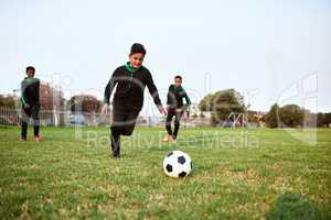 Soccer develops agility, speed and stamina. a group of young boys playing soccer on a sports field.