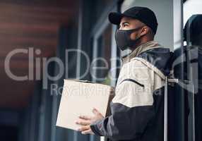 Is anybody home. a masked young man delivering a package to a place of residence.