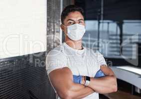 Its my job to ensure everyone stays safe in this facility. Portrait of a young man wearing a face mask in a gym.