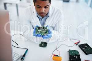 They dont call him the pro for nothing. a young man repairing computer hardware in a laboratory.