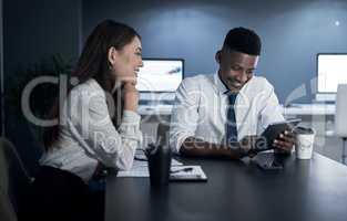 Striking success no matter the time. two businesspeople working together in an office at night.
