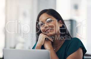 So many bright ideas are popping into her mind. a young businesswoman looking thoughtful while working on a laptop in an office.