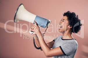 Say it loud and proud. Studio shot of a woman talking over a megaphone.