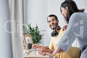 Home life, say hello to work life. a happy young couple working from home.