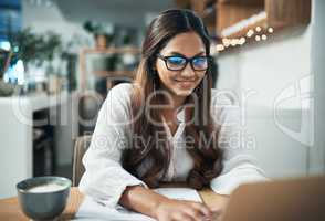 Ive learned a lot of what I know from blogs. a businesswoman using her laptop while working at a cafe.