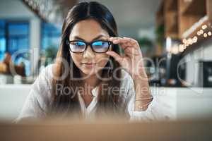 Youll find endless opportunities online. a businesswoman using her laptop while working at a cafe.