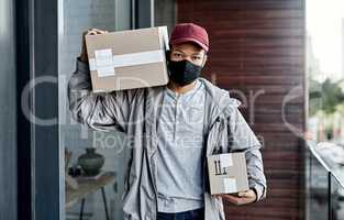 When it comes to safety and convenience, we always deliver. a masked young man delivering a package to a place of residence.