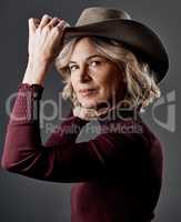 Your confidence is your greatest asset. a mature woman looking stylish against a grey background.