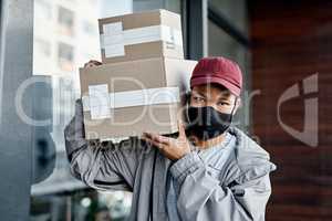You wont find a better delivery service than ours. a masked young man delivering a package to a place of residence.