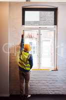 Well have to replace this window. a engineer taking measurements on a construction site.