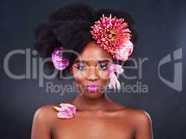 Be bold or italic, never regular. Studio shot of a beautiful young woman posing with flowers in her hair.