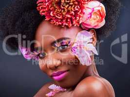 Dont be afraid to experiment with your look. Studio shot of a beautiful young woman posing with flowers in her hair.