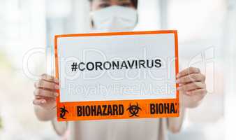 Spread hashtags not viruses. a woman holding up a sign with CORONAVIRUS on it.