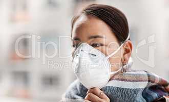 Help prevent the further expansion of coronavirus. a young woman wearing a scarf while out in the city.