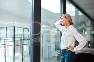 Feelings of unease and apprehension are creeping into her career. a mature businesswoman looking stressed out in an office.