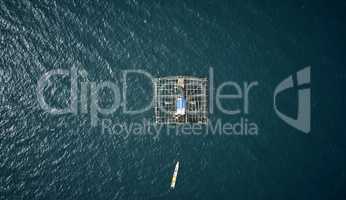 Living close to the fish makes them an easy catch. High angle shot of a built fishing structure floating in the middle of the ocean called a kelong.