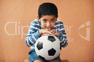 Will you play soccer with me. Portrait of an adorable little boy posing with a soccer ball.