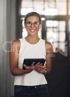 The best device for info on demand. Portrait of a young businesswoman using a digital tablet in a modern office.