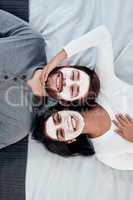 Love has a special way of bringing out your beauty. a young couple getting homemade facials together at home.