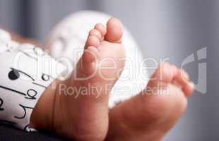Life has only just begun. an unrecognisable babys adorable feet at home.