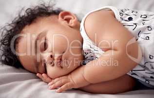 Theres no sight sweeter than a sleeping baby. an adorable baby boy sleeping peacefully on the bed at home.