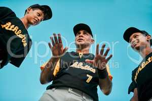 Remember the most important part is to have fun. a baseball coach talking to his team while out on the pitch.