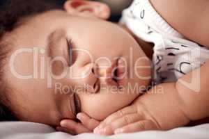 Gotta recharge those baby batteries. an adorable baby boy sleeping peacefully on the bed at home.