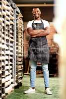 Come and check out the best bakery in town. a confident young man working in a bakery.